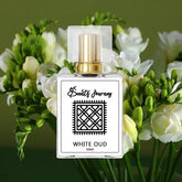 White Oud perfume bottle with gold cap, surrounded by white flowers, ideal fragrance choice