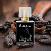 Black Afghano perfume bottle with gold cap on wooden surface surrounded by dark beans